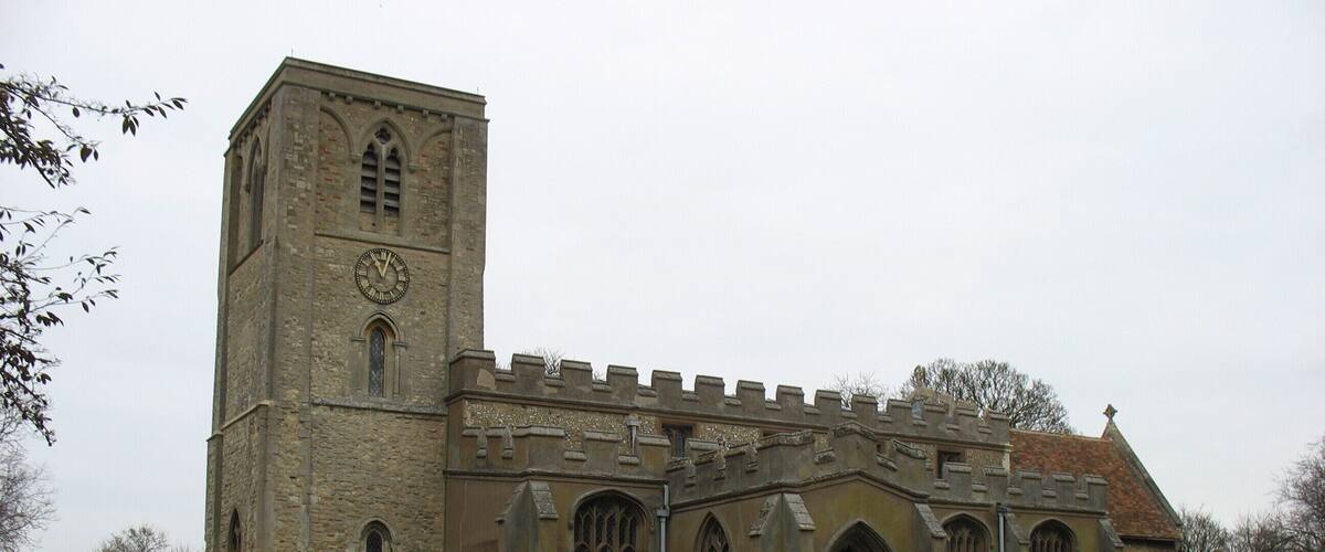 A historic church with a tall bell tower and arched windows.