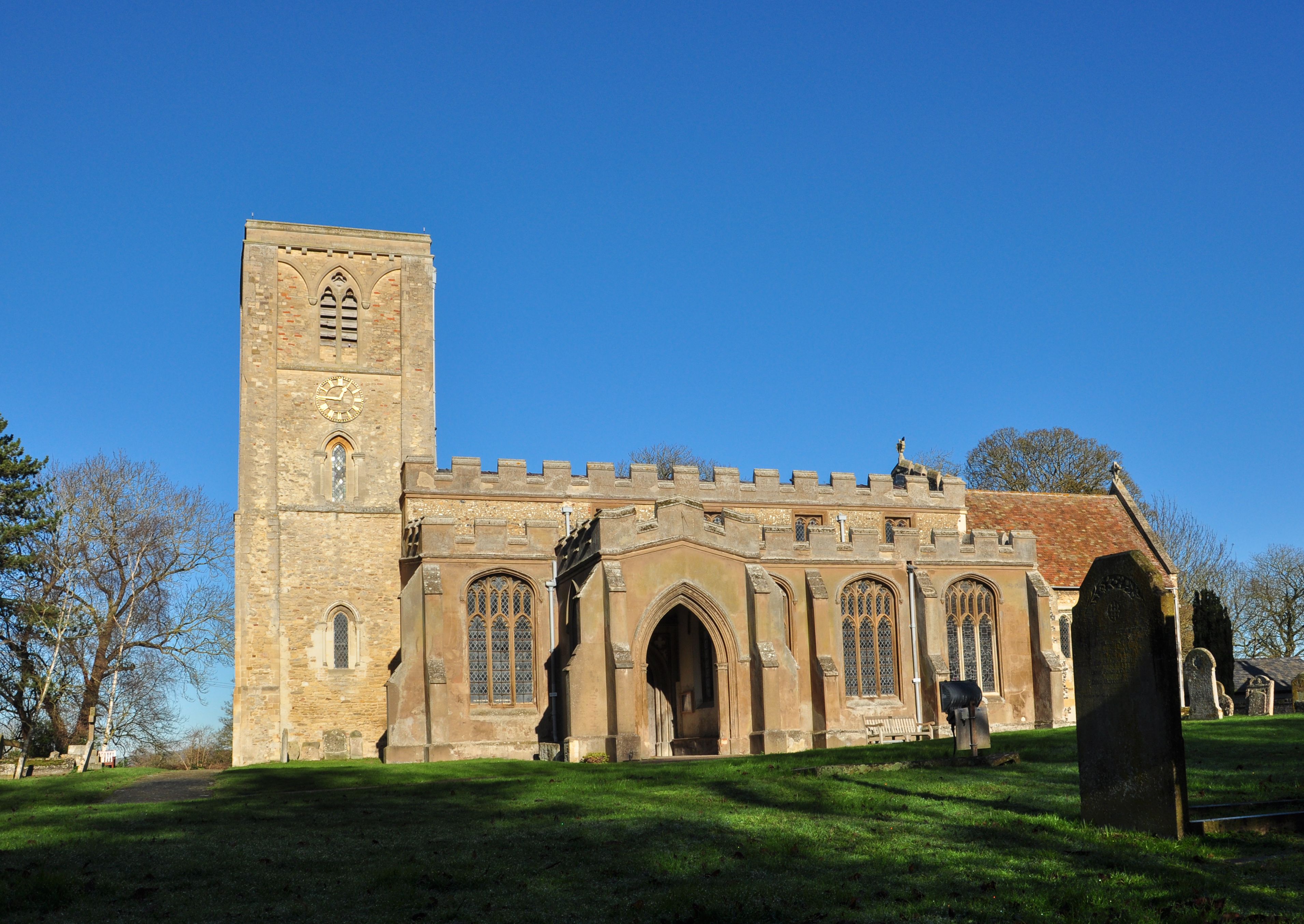 A historic church with a tall bell tower and arched windows.