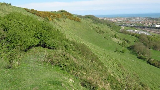 Cheriton Hill above Folkestone The Saxon Shore Way and North Downs Way (long distances paths) heads along the ridge of this steep escarpment heading to Capel-le-Ferne. On the right, at the bottom of the escarpment is the Channel Tunnel Rail Terminal.
