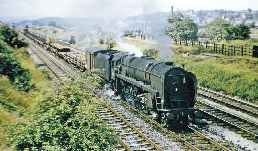Up P.W. Engineers' train approaching Mirfield. View NW, as SE1919 : Eastbound freight on Calder Valley main line approaching Mirfield, towards Manchester, by L&Y via Todmorden or by LNW via Huddersfield: Calder Valley main lines. The locomotive is BR 9F 2-10-0 No. 92126 (built 3/57, withdrawn 8/67). {In colour, for a change}.