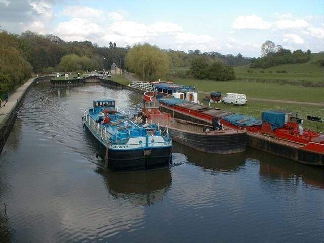 Un canal con barcos amarrados en un muelle.