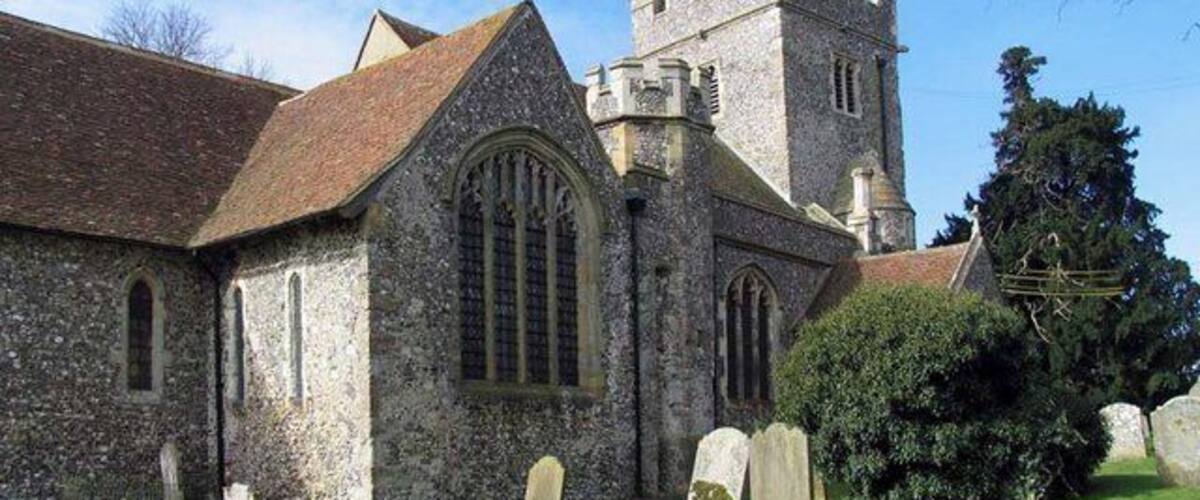 A church with a tower and a graveyard.