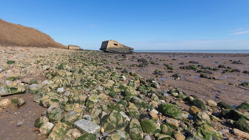 Park up and stroll along the coastal footpath where erosion of the cliffs has seen these two WWII lookout posts fall onto the beach.