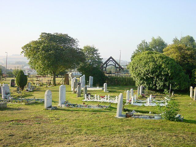 Leysdown Cemetery. Nicely situated adjacent to Paradise (a farm). The lych gate is inscribed "1994 To the memory of those who gave their lives in the service of their country". Looking north.