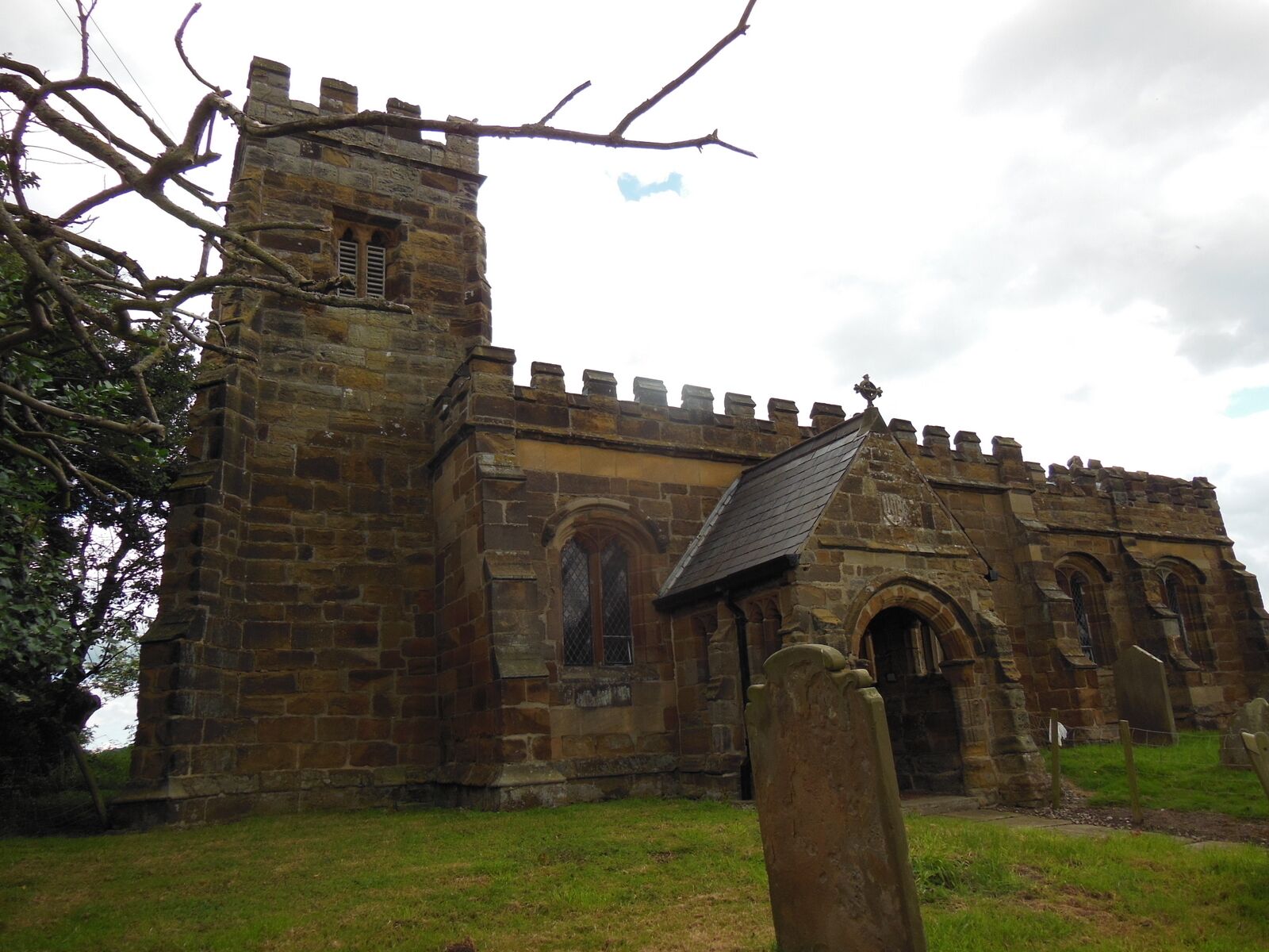 A stone church with arched windows and a bell tower.