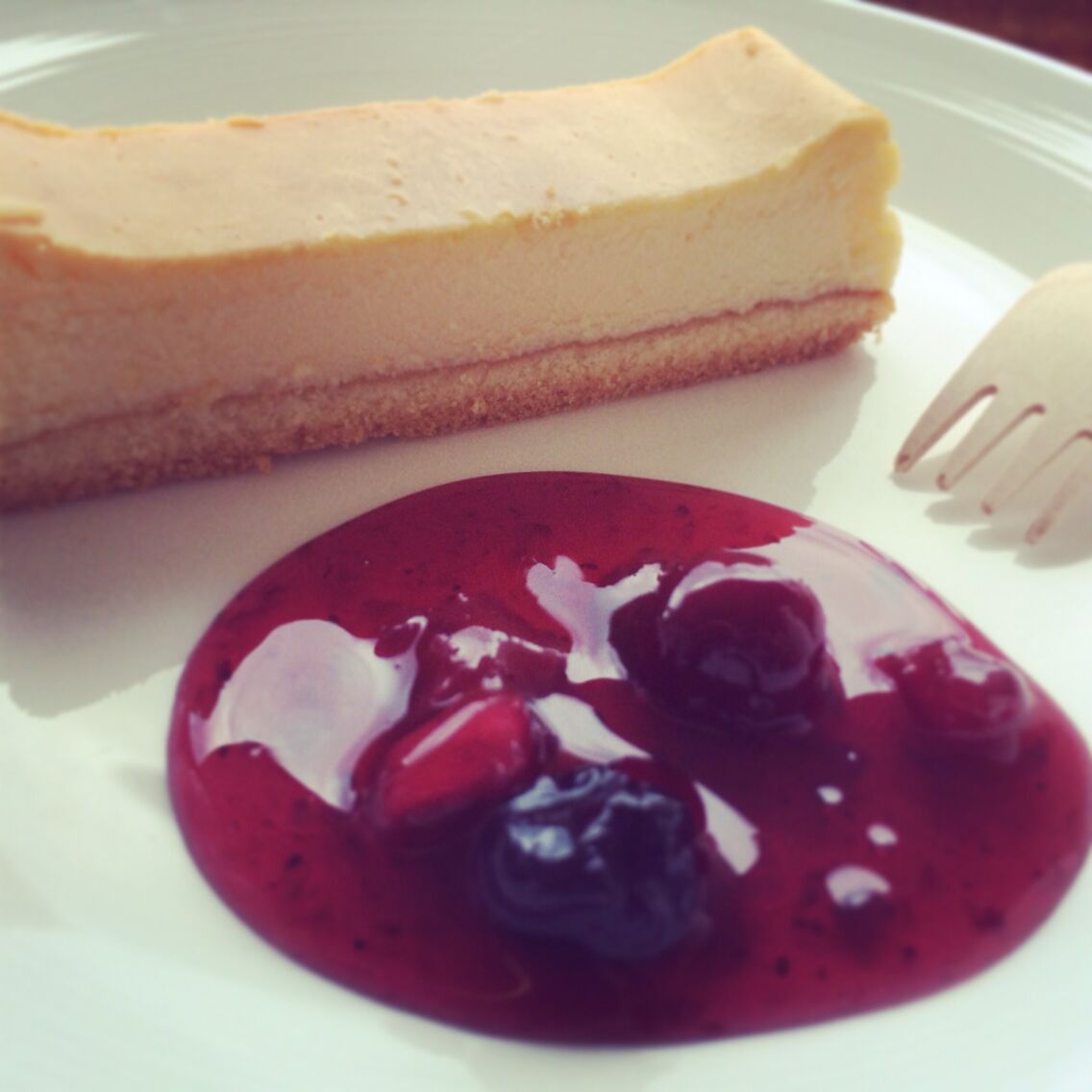 A slice of cheesecake with a berry compote.