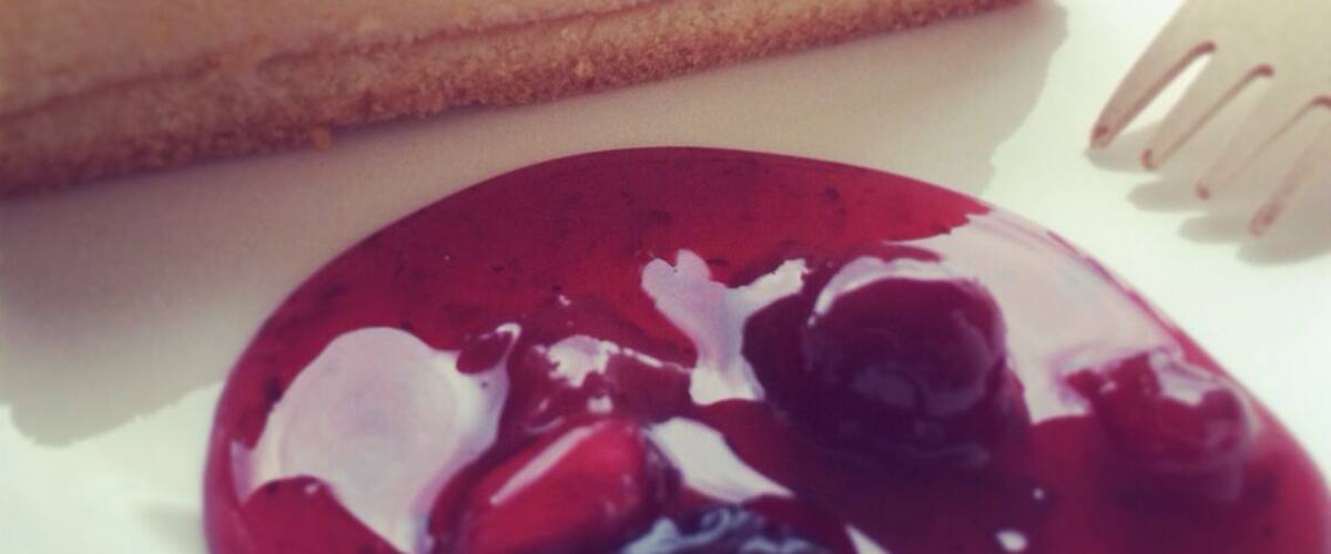 A slice of cheesecake with a berry compote.
