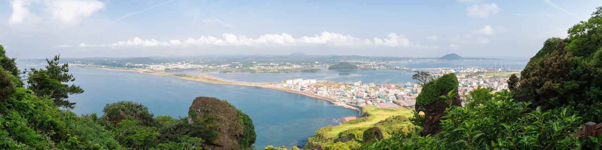 Panoramic view of sea and city from Seongsan Ilchulbong Tuff Cone in Jeju Island, Korea