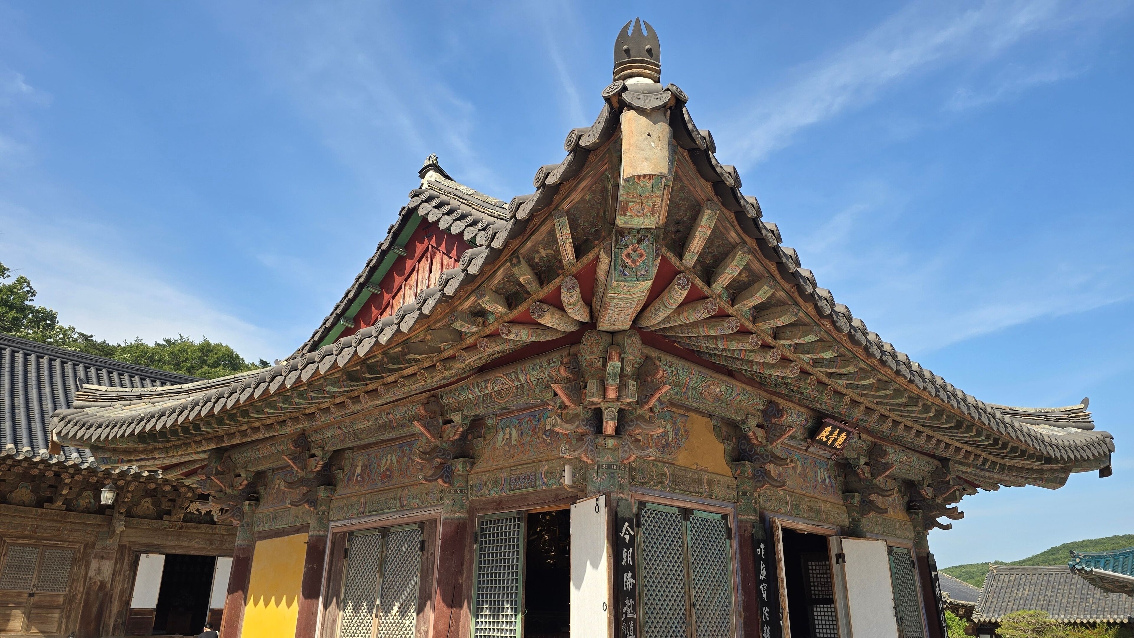 A traditional Chinese building with ornate roof tiles and intricate carvings.