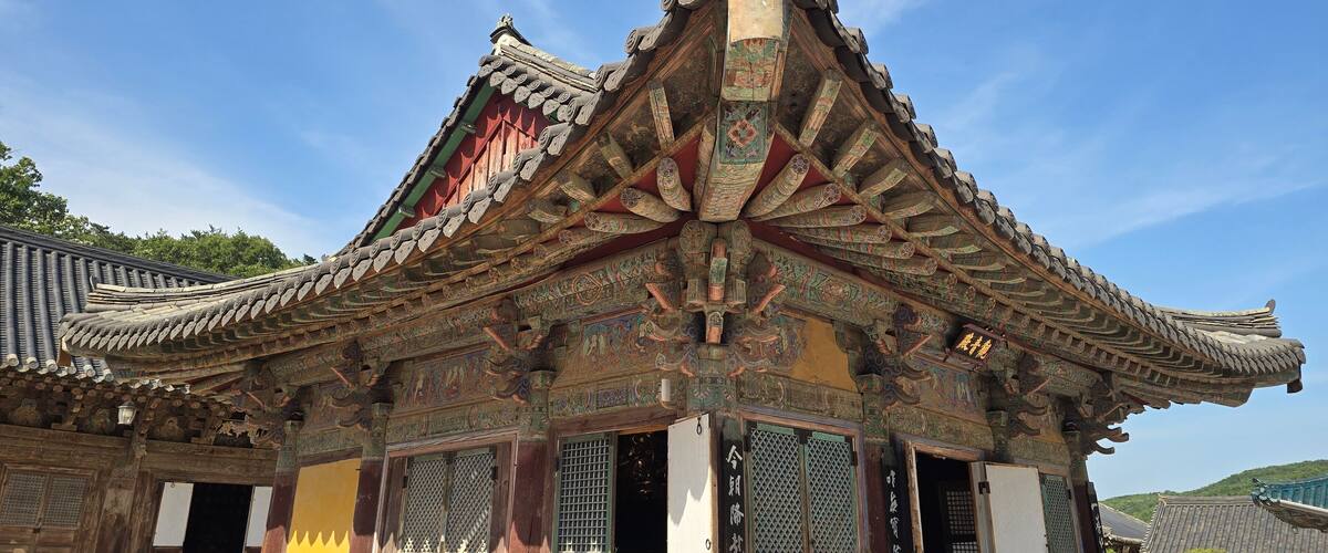 A traditional Chinese building with ornate roof tiles and intricate carvings.