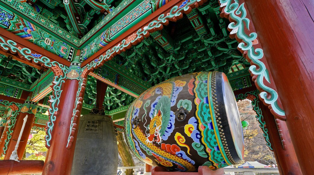 Bronze bell and painted drum in highly decorated pavilion at Magoksa Buddhist temple, Gonju, South Korea