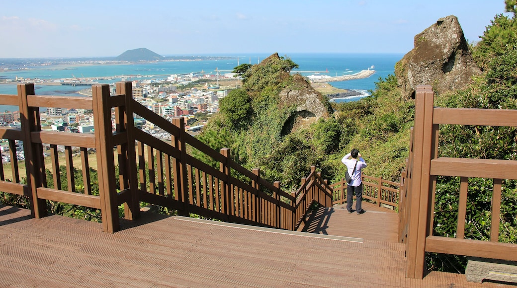 Tourist takes photo view from Seongsan Ilchulbong in Jeju Island, South Korea