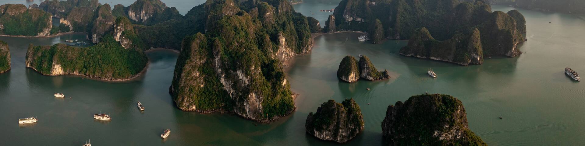 A coastal landscape with numerous limestone islands surrounded by water.