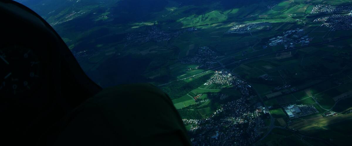 An aerial view of a landscape with fields, roads, and a small town.
