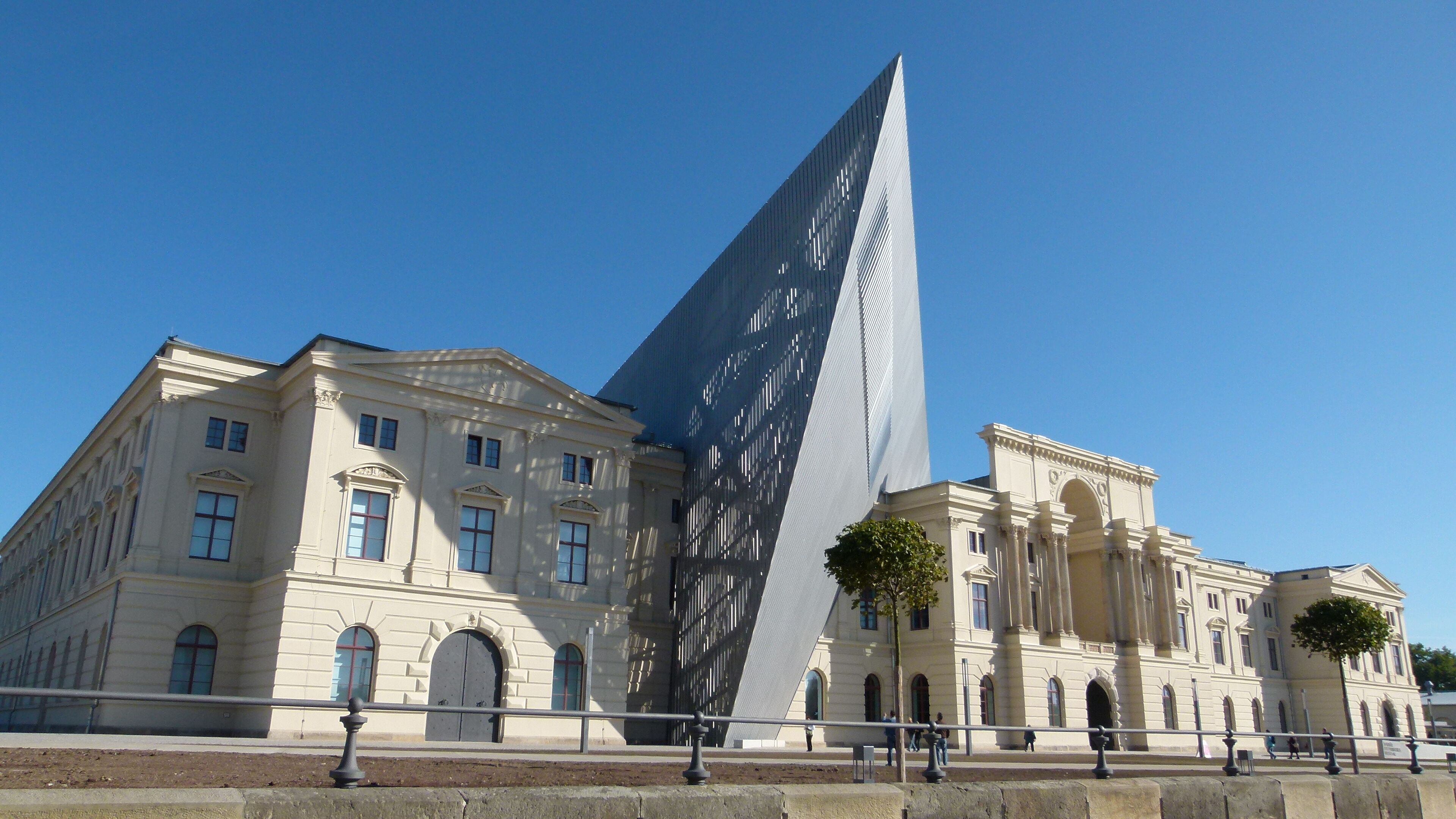 A classical building with a modern glass structure.