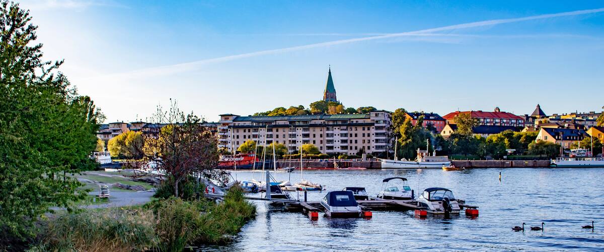 Small Boats Parked by a Local Park next to the Sickla Canal in the Södra Hammarbyhamnen Neighborhood of Stockholm, Sweden