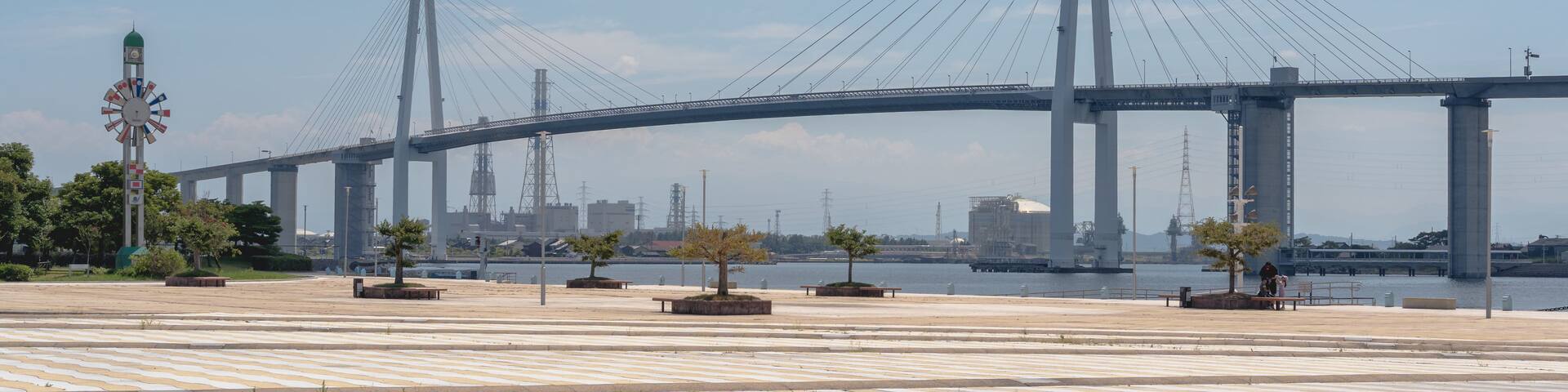 A large suspension bridge with multiple towers and cables spanning a body of water.