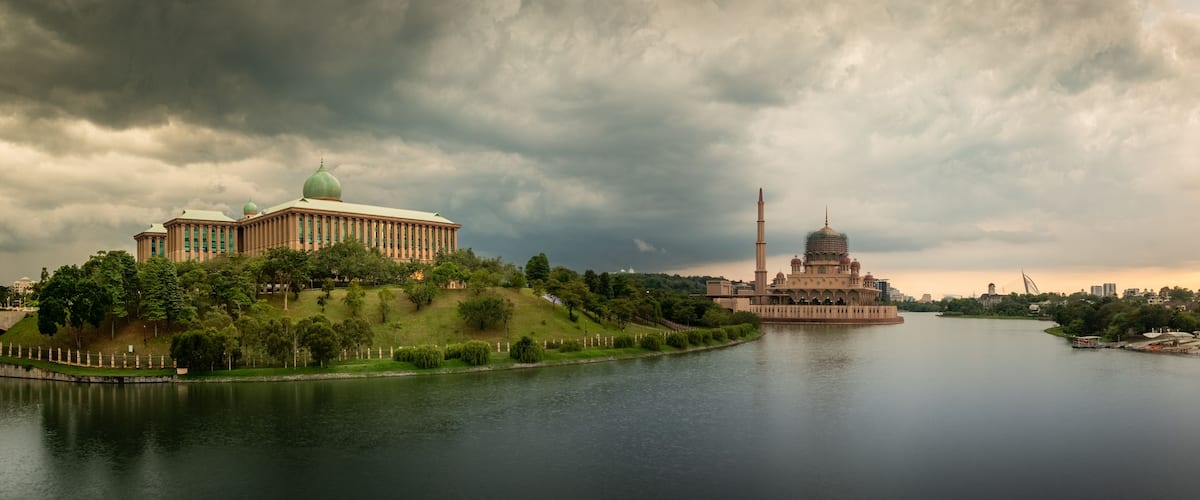 A river with a large building on the left and a pagoda-like structure in the center.