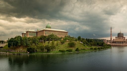 A river with a large building on the left and a pagoda-like structure in the center.