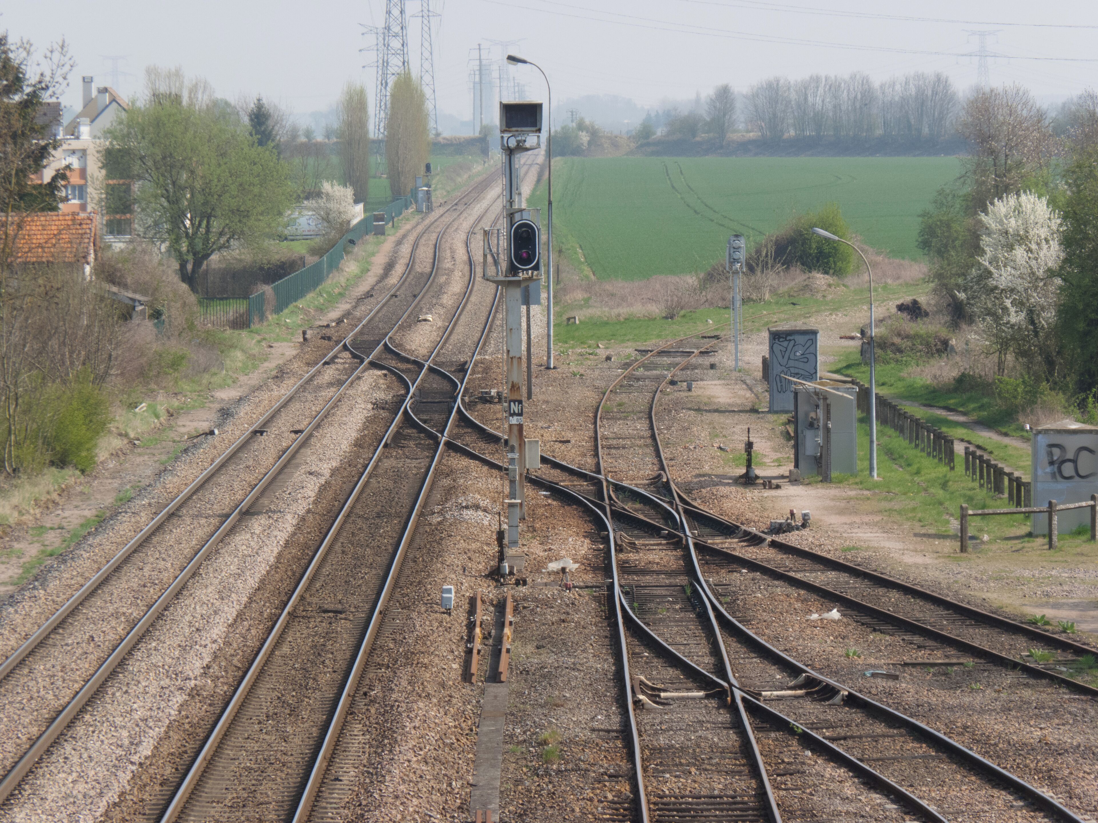 Railway tracks with multiple switches and a signal light.