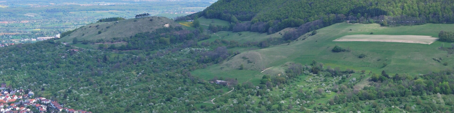 Owen and the castle Teck at the Albtrauf of the Swabian Alb in Baden-Württemberg.The mountain Teckberg and its smaller neighbour Hohenbol are both extinct volcanoes. Except for the meadow orchards on the slopes the area is protected as a Naturschutzgebiet.