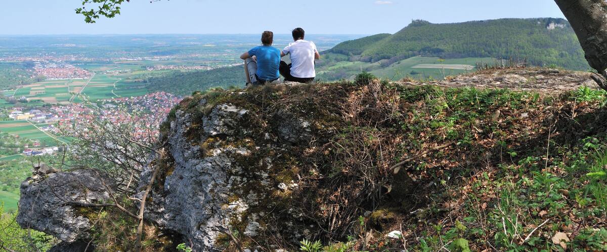 Lookout point on Bruken Rock in Swabian Jura in the German Federal State Baden-Württemberg. In the background is seen Owen and the castle Teck.