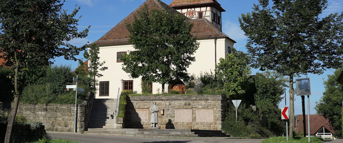 A church with a red-tiled roof and a bell tower.