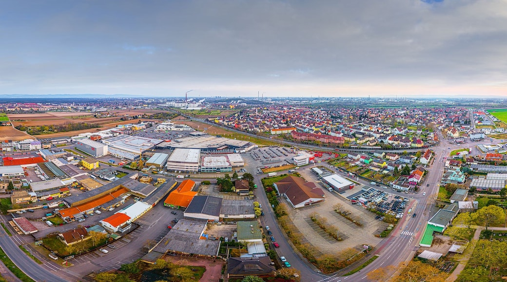 An aerial view of a town with industrial buildings, roads, and green fields.