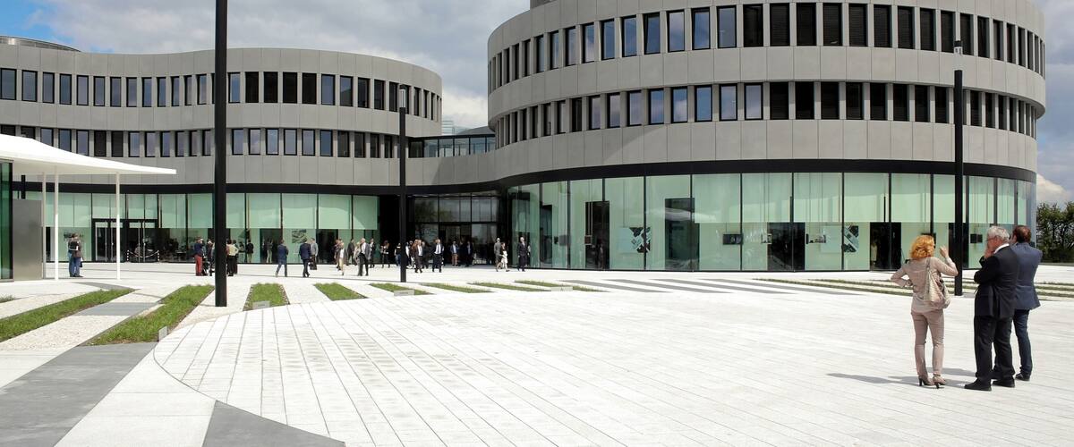 A modern building with circular architecture and glass windows.