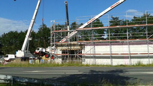 A truck-mounted crane crashes on the construction site of a supermarket in Modau, Ober-Ramstadt, Germany.
