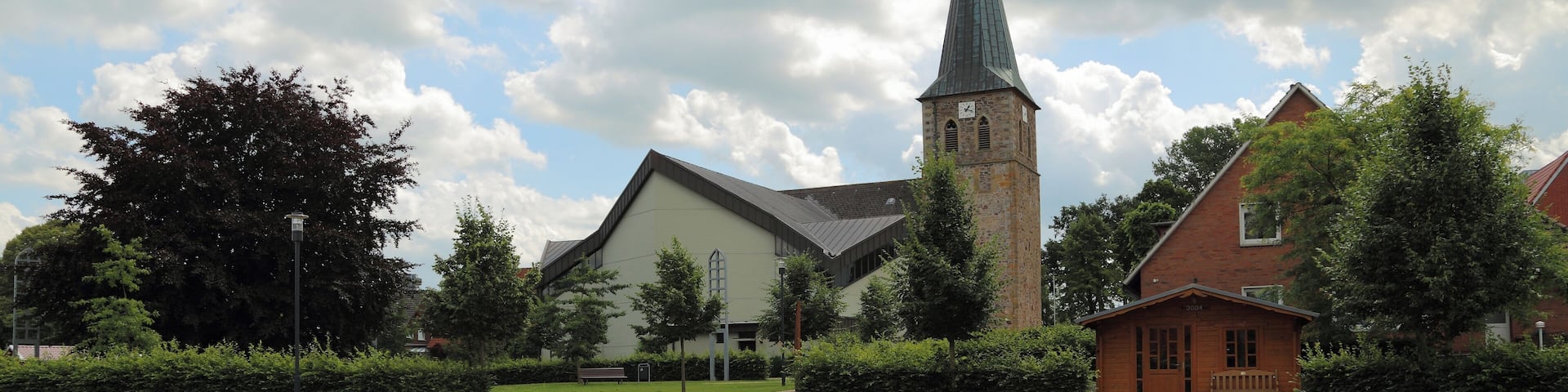 So called „Ecumenism Midst“ (Ökumenische Mitte) in Baccum, a city district of Lingen (Ems), Landkreis Emsland, Lower Saxony, Germany. The square is situated between the Reformed Church and the Roman Catholic St. Antonius Church.
