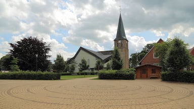 So called âEcumenism Midstâ (Ăkumenische Mitte) in Baccum, a city district of Lingen (Ems), Landkreis Emsland, Lower Saxony, Germany. The square is situated between the Reformed Church and the Roman Catholic St. Antonius Church.