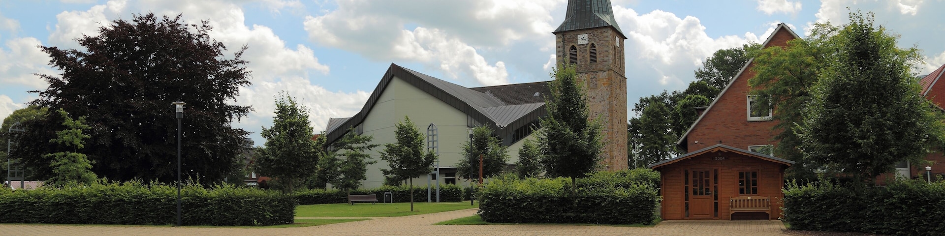 So called „Ecumenism Midst“ (Ökumenische Mitte) in Baccum, a city district of Lingen (Ems), Landkreis Emsland, Lower Saxony, Germany. The square is situated between the Reformed Church and the Roman Catholic St. Antonius Church.
