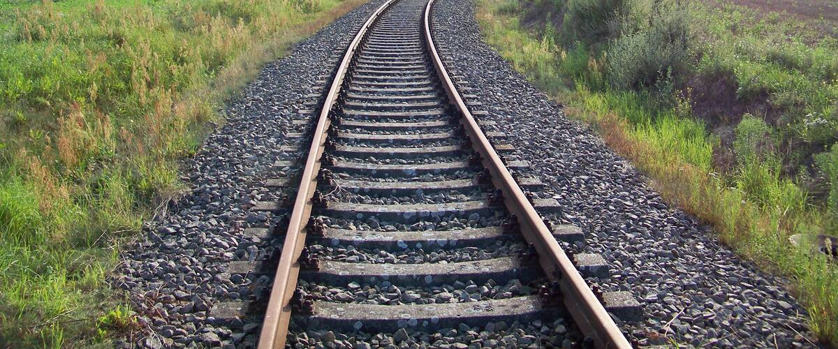 A railway track curving through a field.