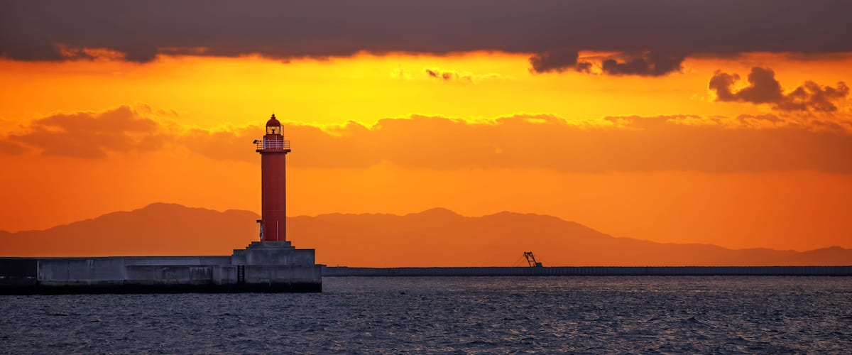 Lighthouse at Osaka Port Against a Dramatic Sunset, Japan
