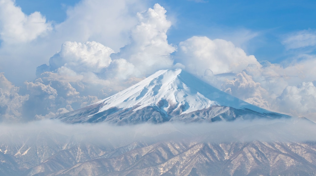 Beautiful Fuji mountain with snow cover on the top with could. Mount fuji from lake kawaguchi side. Panorama view of snow mountains and clouds.