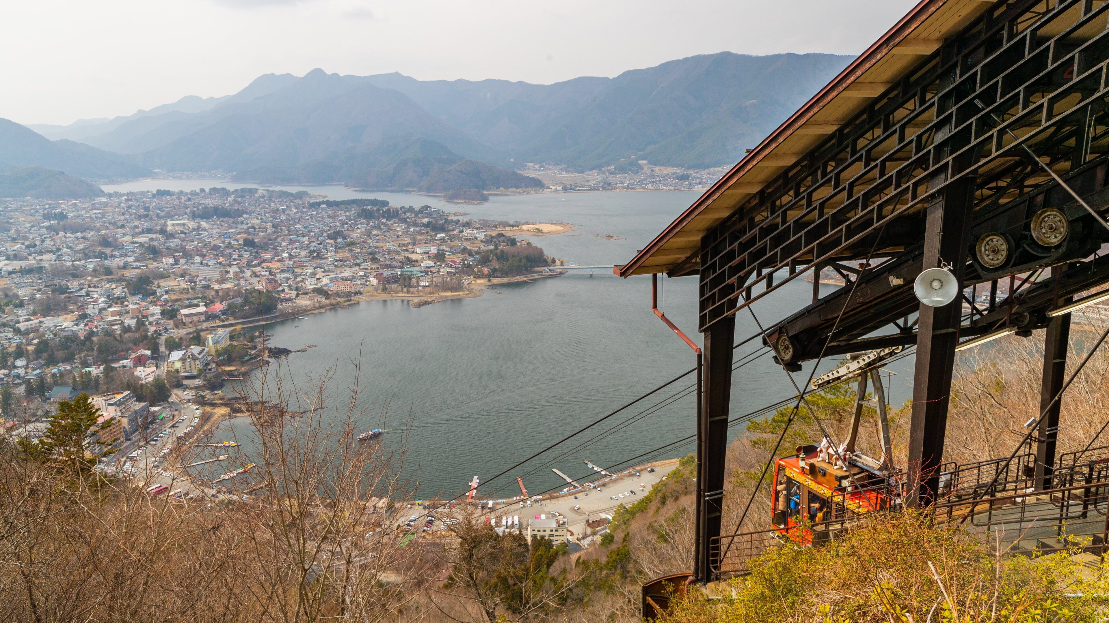 Mt. Kachi Kachi Ropeway showing a gondola, landscape views and a coastal town