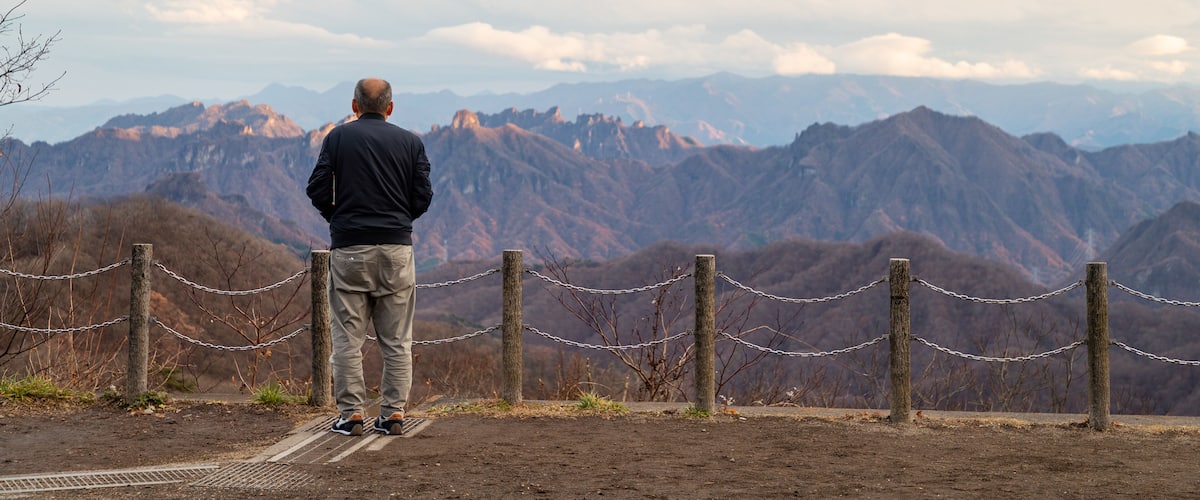 Usui Pass Observation Platform featuring views and tranquil scenes as well as an individual male