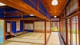 A traditional Japanese room with tatami mats, wooden beams, and shoji screens.