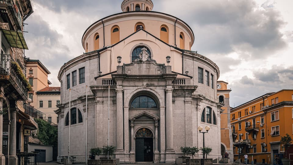 A historic building with a dome, arched windows, and a central entrance.