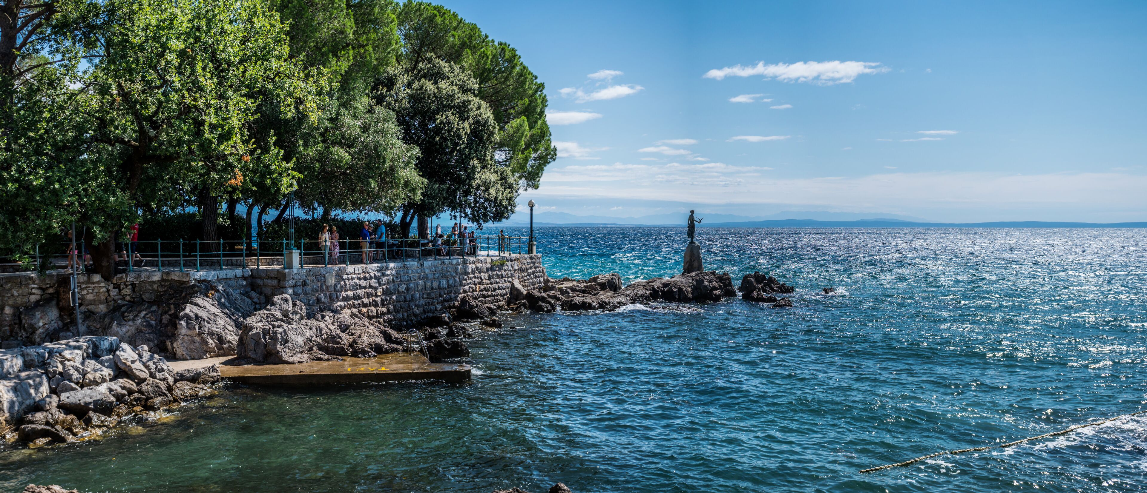 The Maiden with the Seagull. The statue is the symbol of Opatij, Croatia. Beautiful panoramic view of sea and sky.