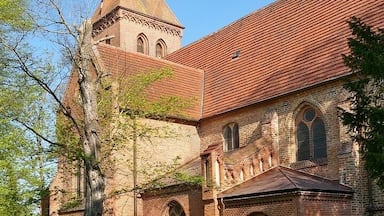 A historic church with a tall spire and arched windows.