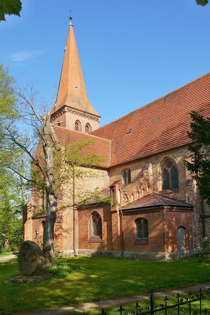 A historic church with a tall spire and arched windows.