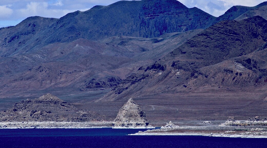#BVSBlue
Pyramid Lake is an endorheic lake. It has no outlet, with water leaving only by evaporation, or sub-surface seepage. This was taken in Sutcliffe, which is on the west shore of Pyramid Lake along State Route 445. The name of the lake comes from the impressive cone or pyramid shaped tufa formations found in the lake and along the shores. The largest such formation, Anaho Island, shown at the center, is home to a large colony of American white pelicans and is restricted for ecological reasonsA remnant of the Pleistocene Lake Lahontan (~890 feet deep), the lake area was inhabited by the 19th-century Paiute, who fished the Tui chub and Lahontan cutthroat trout from the lake.
