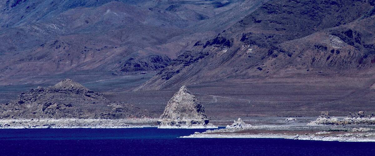 #BVSBlue
Pyramid Lake is an endorheic lake. It has no outlet, with water leaving only by evaporation, or sub-surface seepage. This was taken in Sutcliffe, which is on the west shore of Pyramid Lake along State Route 445. The name of the lake comes from the impressive cone or pyramid shaped tufa formations found in the lake and along the shores. The largest such formation, Anaho Island, shown at the center, is home to a large colony of American white pelicans and is restricted for ecological reasonsA remnant of the Pleistocene Lake Lahontan (~890 feet deep), the lake area was inhabited by the 19th-century Paiute, who fished the Tui chub and Lahontan cutthroat trout from the lake.