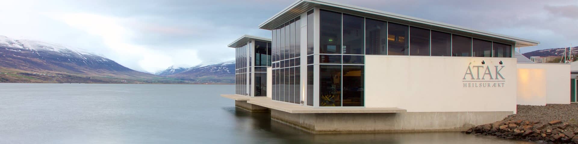 Akureyri which includes modern architecture and general coastal views