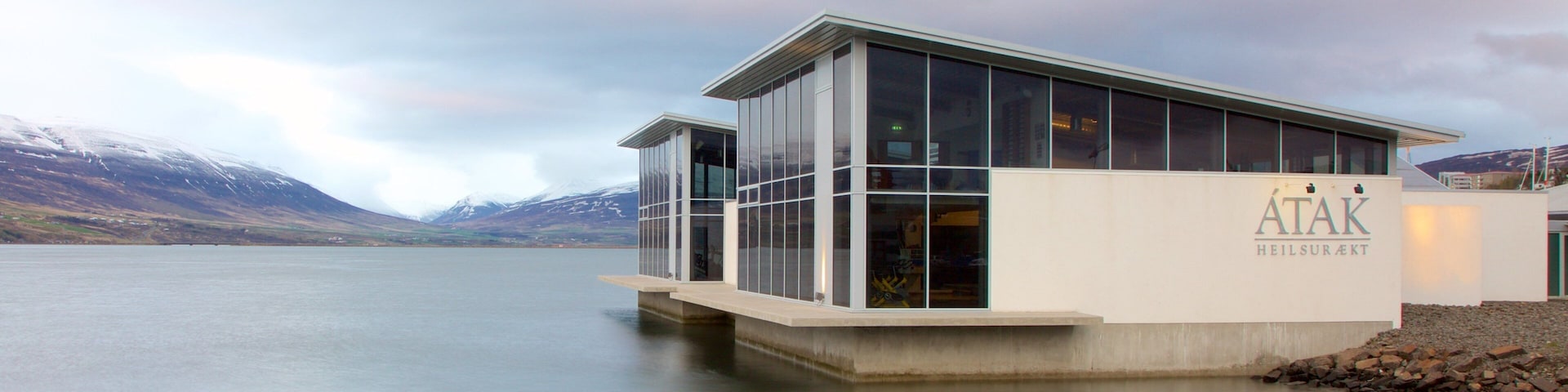 Akureyri which includes modern architecture and general coastal views