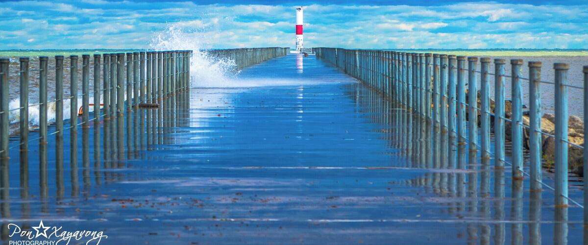 If u ever hike or walk near Ontario Beach park along the Rochester harbor ull see a lighthouse far away but be very careful because the wave from the ocean can hit u and get u wet.