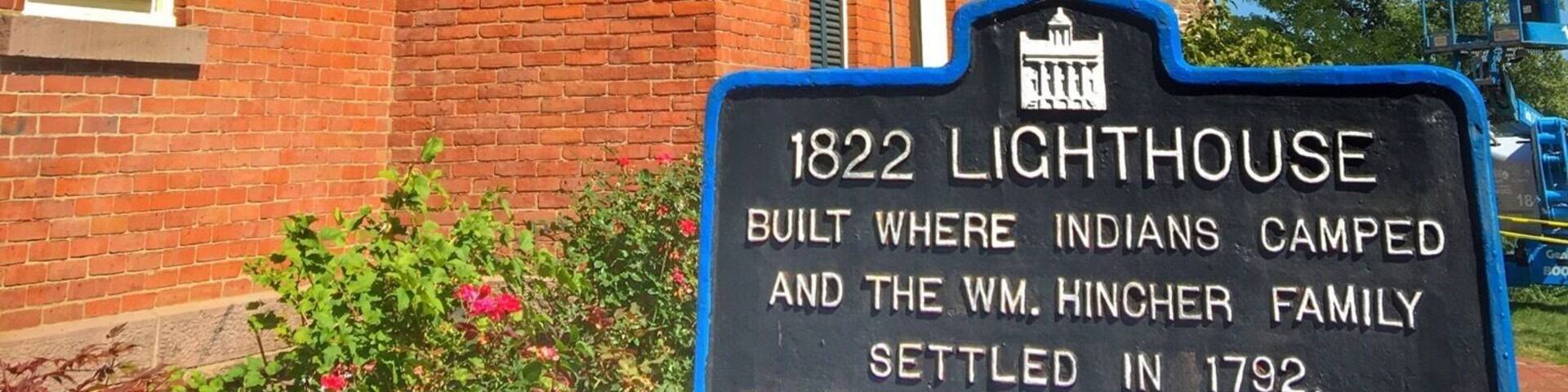 A brick building with a sign about the 1822 Lighthouse, where Indians camped and the WM. Hincher family settled in 1792.
