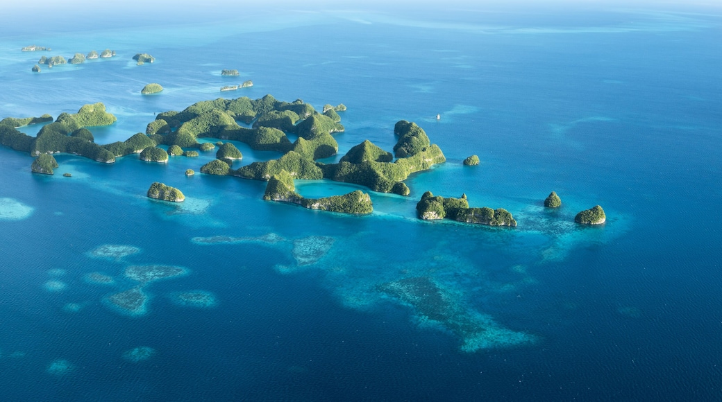 An aerial view of a cluster of islands with clear blue waters and coral reefs.